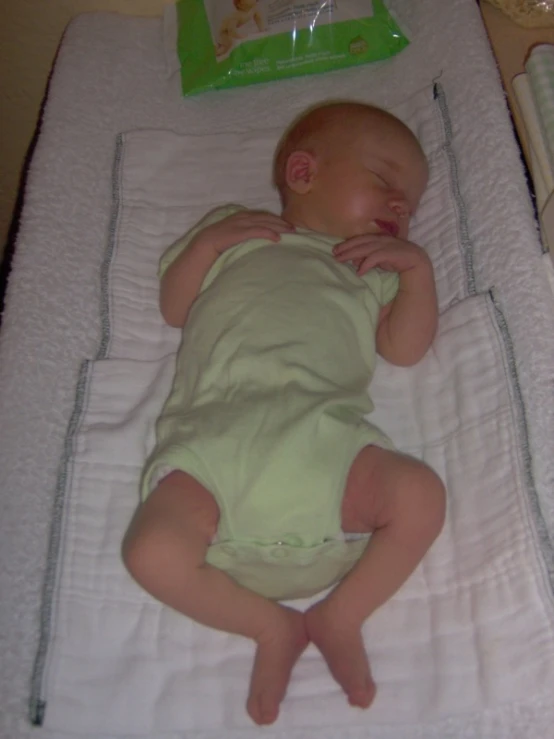 a baby is laying down on the pillow in his bed