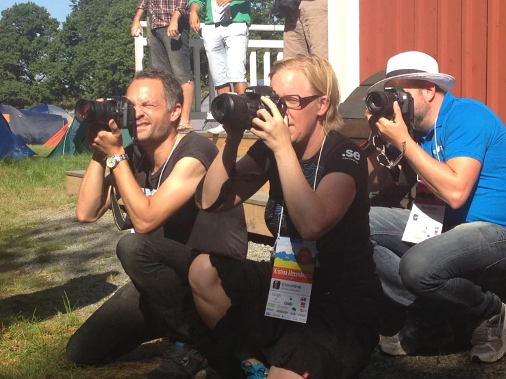 people are taking pictures while sitting on a bench