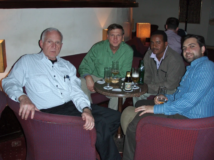 a group of men sitting around a table