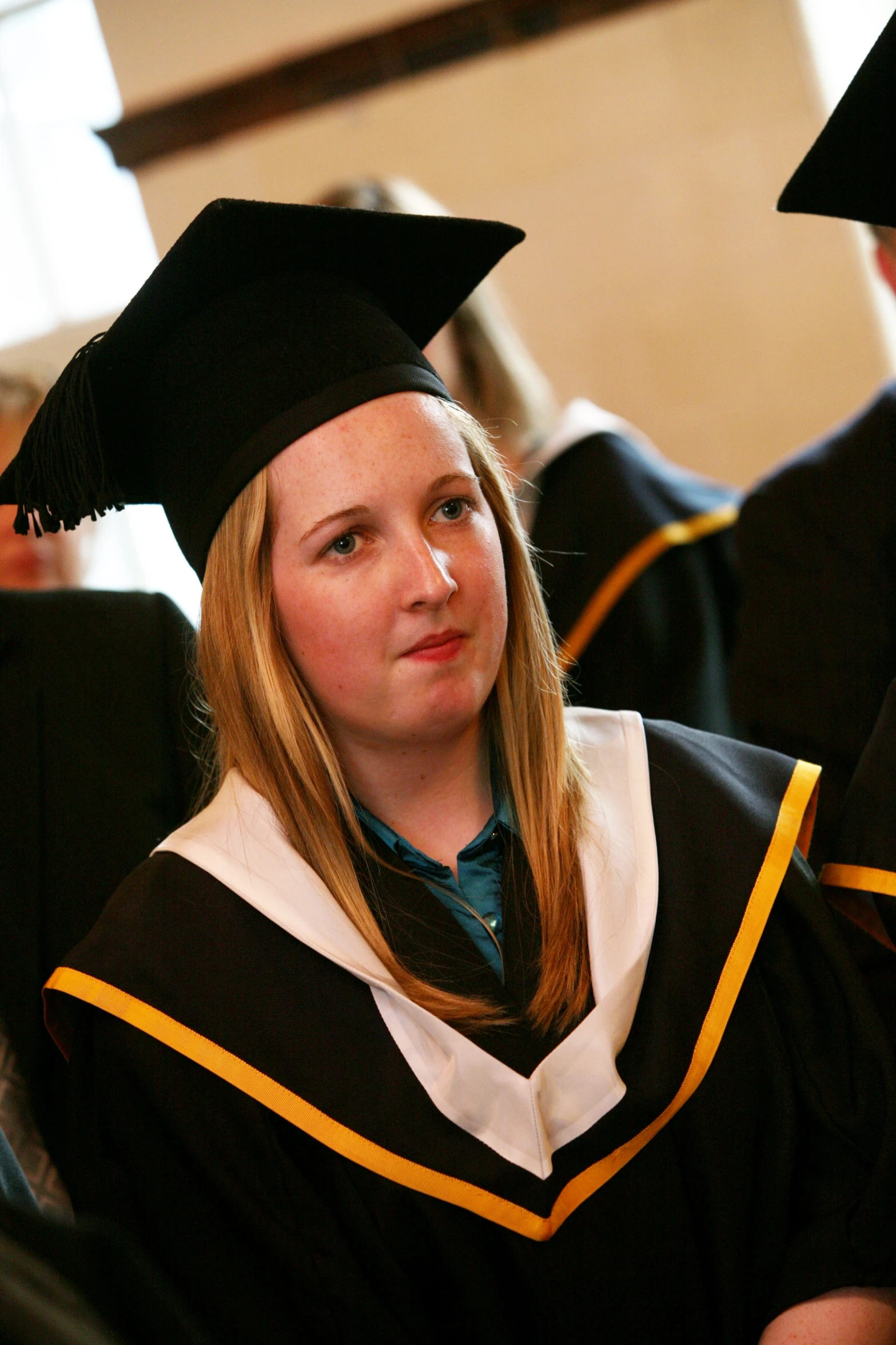 a woman in cap and gown with a smile on her face