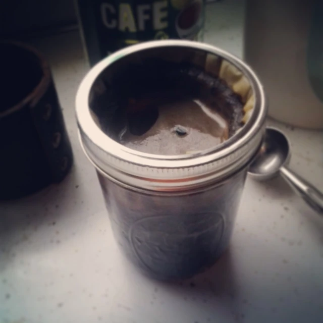an old coffee cup is on a counter