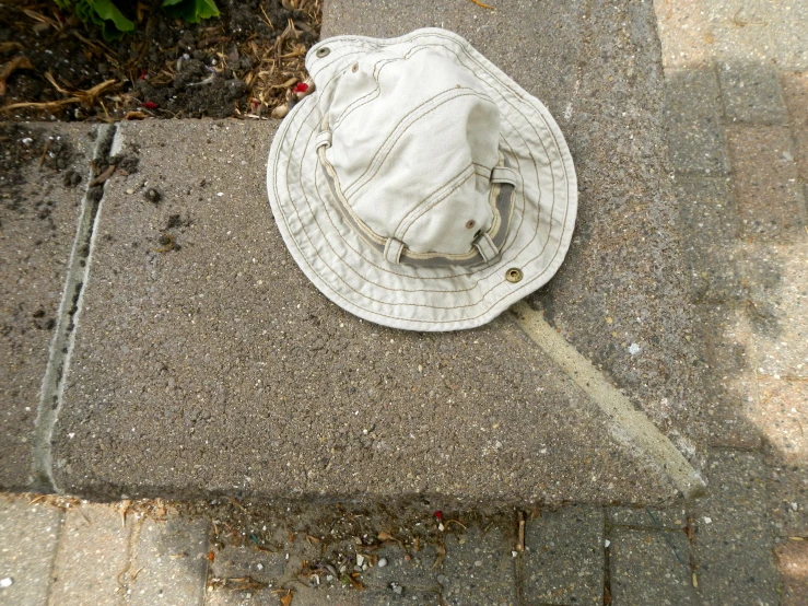 there is a hat on the ground with dirt