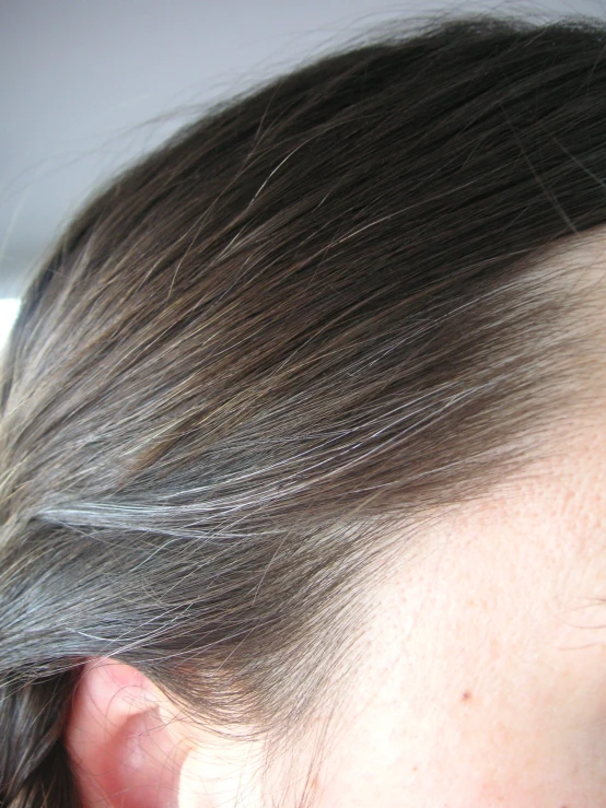 a woman with a gray hairdo in an unmade room