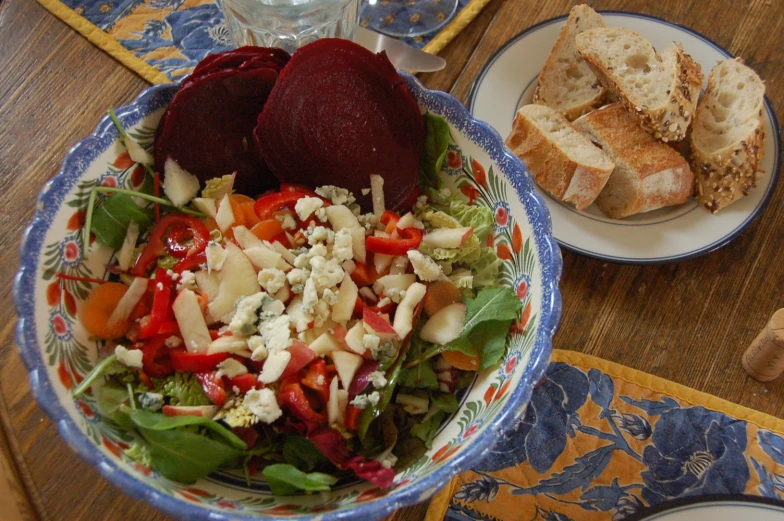 a bowl with bread and fresh salad in it