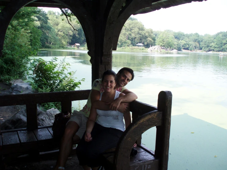 two woman pose in the gazebo on a sunny day