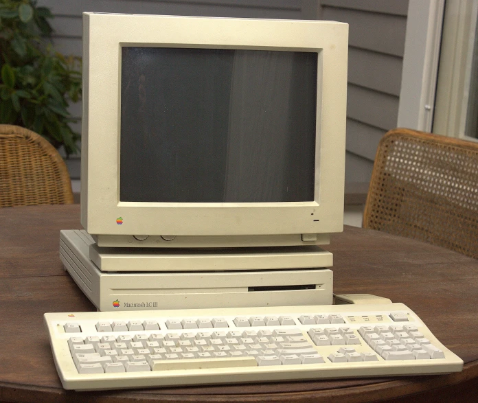 an apple computer with a keyboard sitting on a table