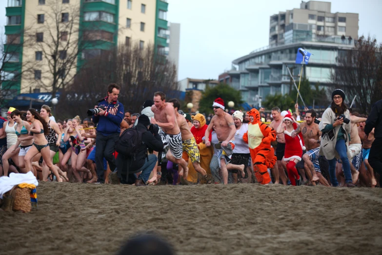 a crowd of people dressed in bathing suits and clowns