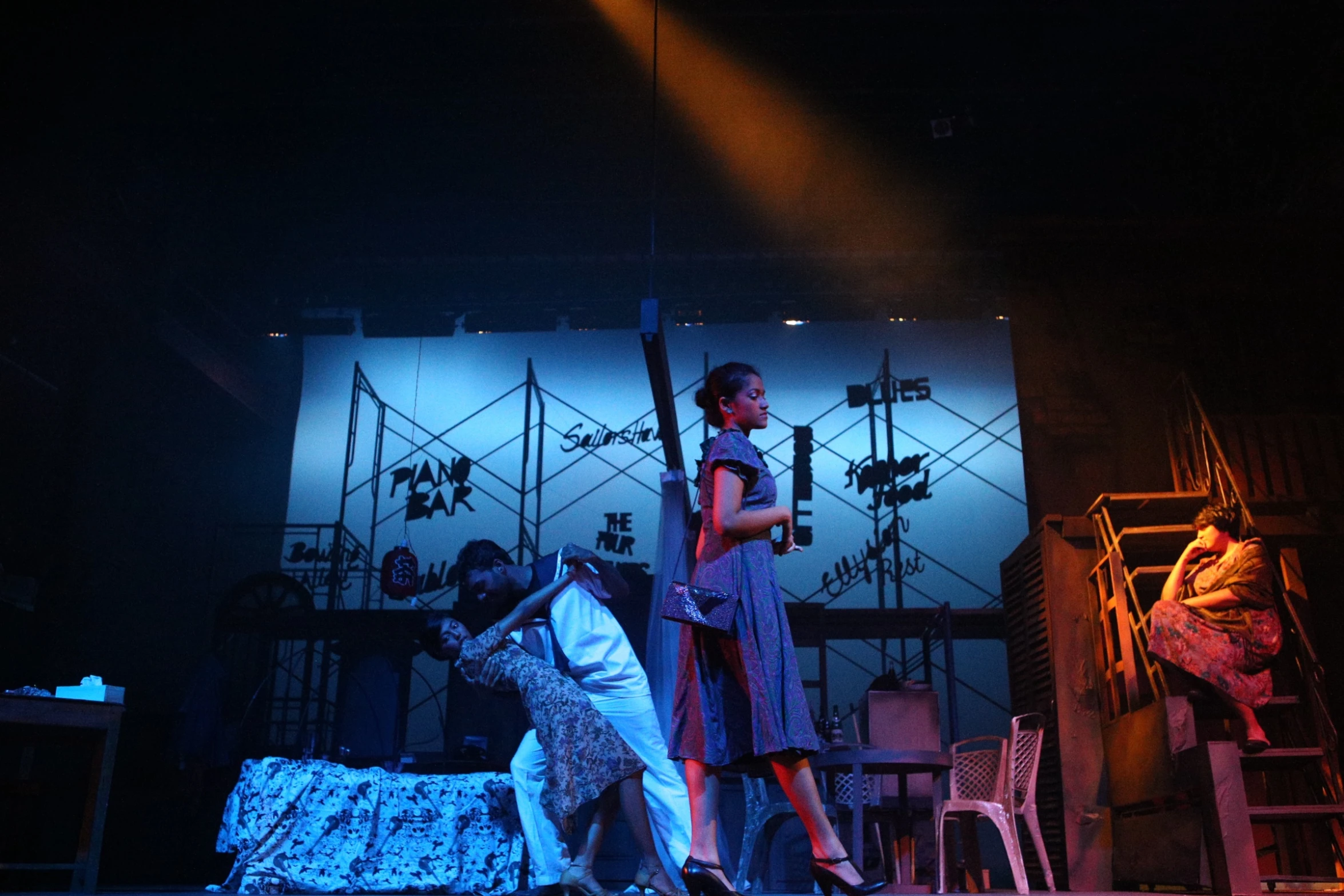 two people on stage standing next to a dog and an easel