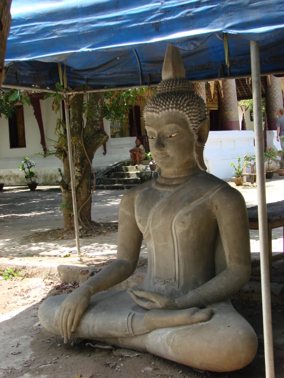 a statue that is sitting under a canopy