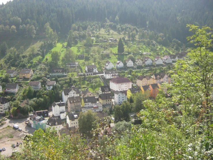 village in hilly area surrounded by trees