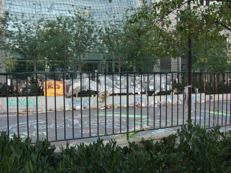 a gated area with many vehicles behind a fence