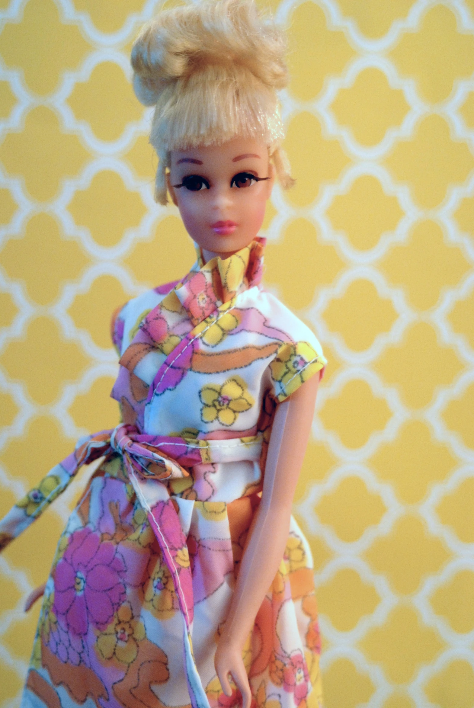 doll wearing a floral outfit standing with a handbag