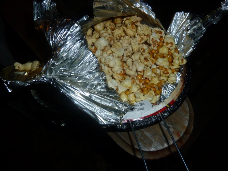the pizza with popcorn is wrapped in foil