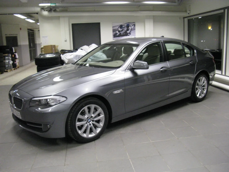 a silver car sits parked in a garage