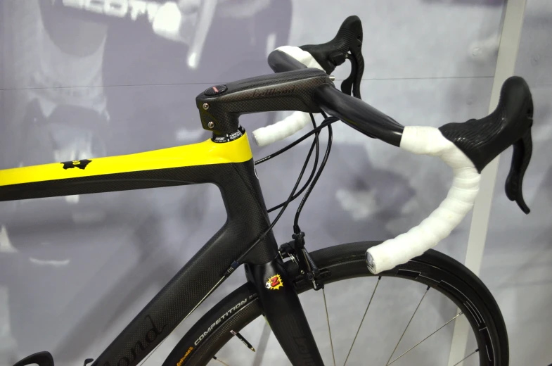 the front of a black and yellow bicycle