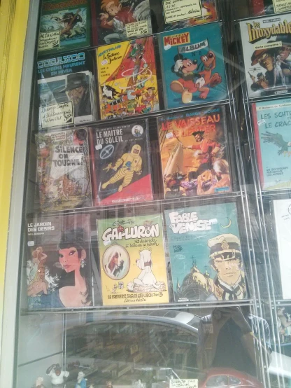 the display case has cartoons, cartoons, and comics
