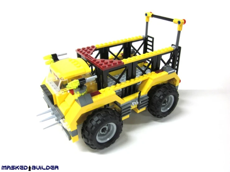 a yellow toy tractor with four large forks on it