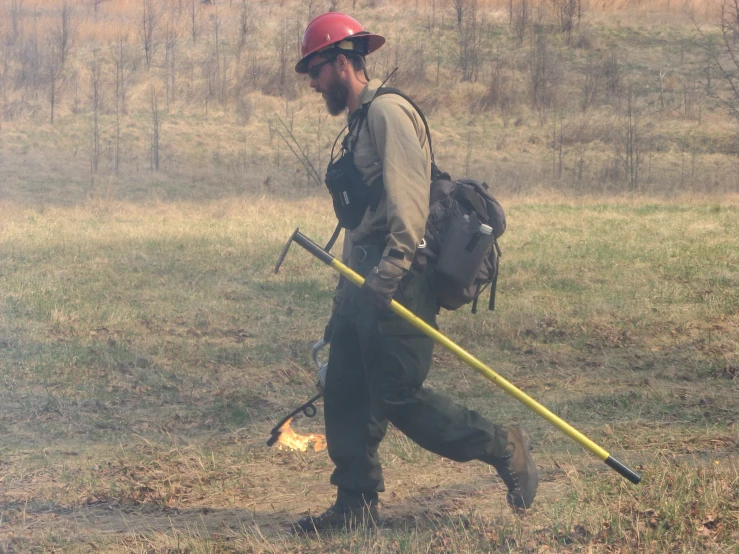 man in a hat and hiking gear with two walking stick