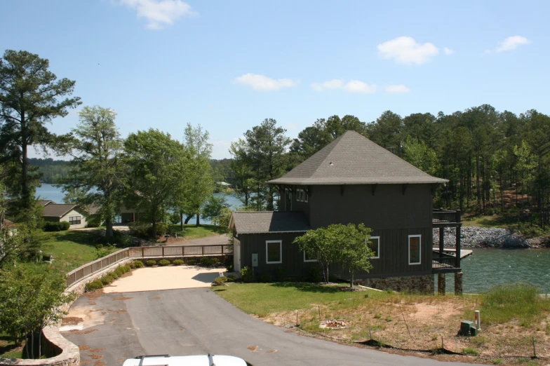 a house next to the water is shown from the sky