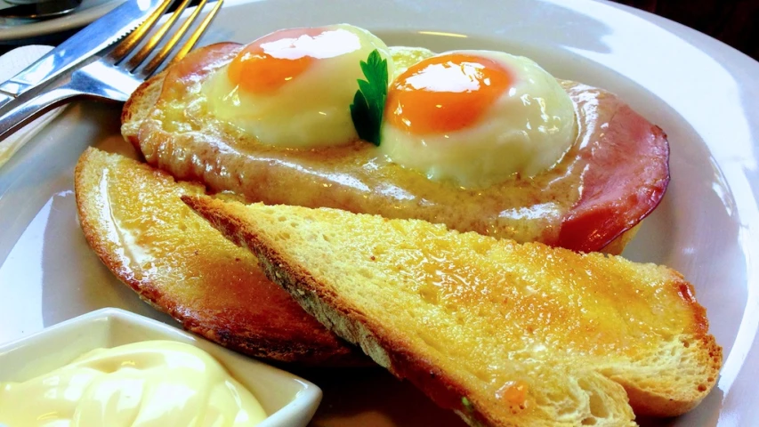 breakfast on a plate consisting of bacon and egg