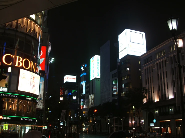 buildings in a city lit up with different colors at night