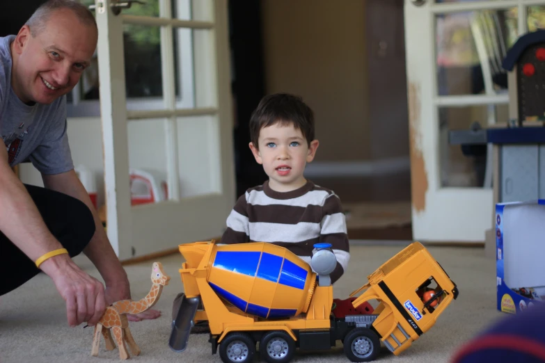 a  holding onto a toy truck