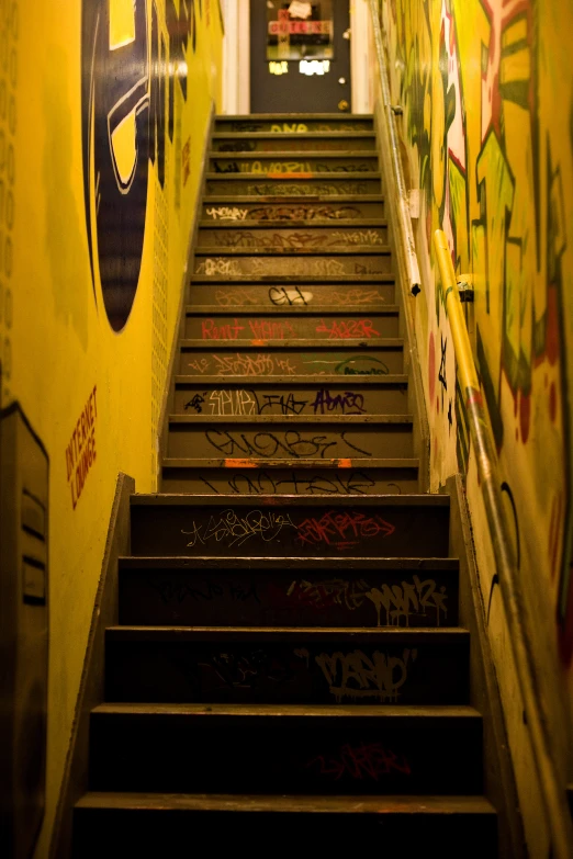 a long stairway with steps covered in graffiti