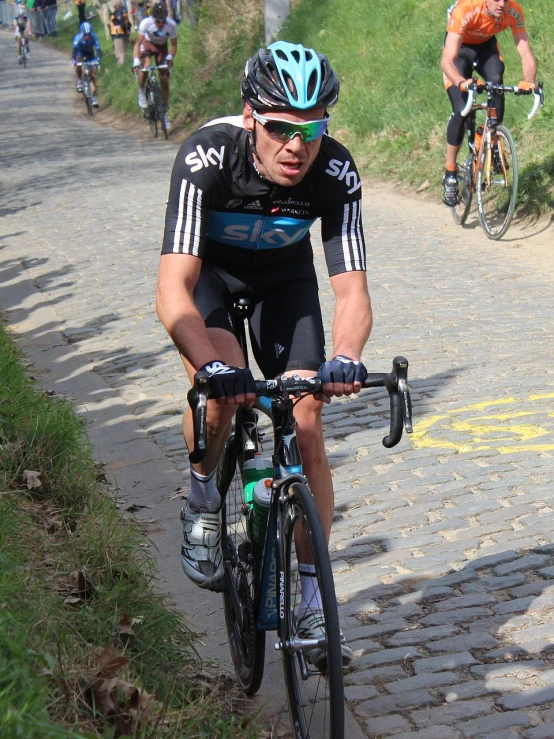 a man is racing on a bike in the sun