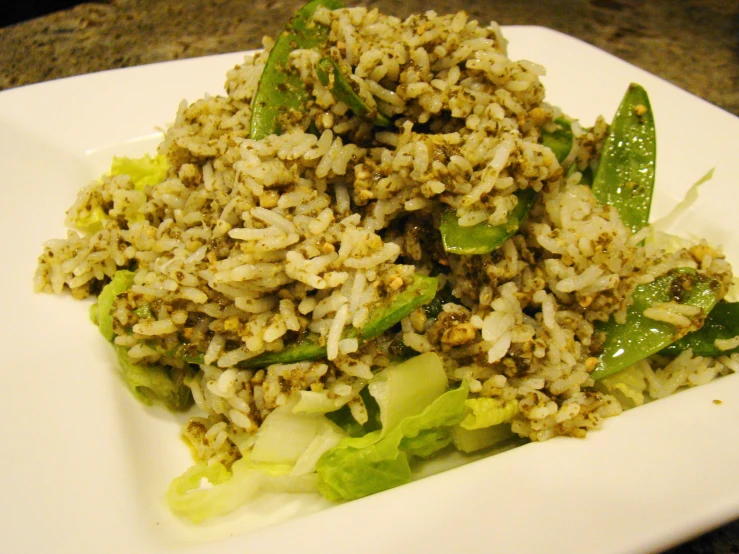 plate with rice, greens and some type of sauce