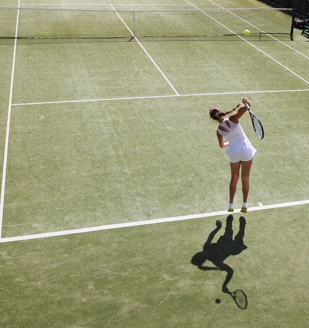 a woman taking a swing at a tennis ball