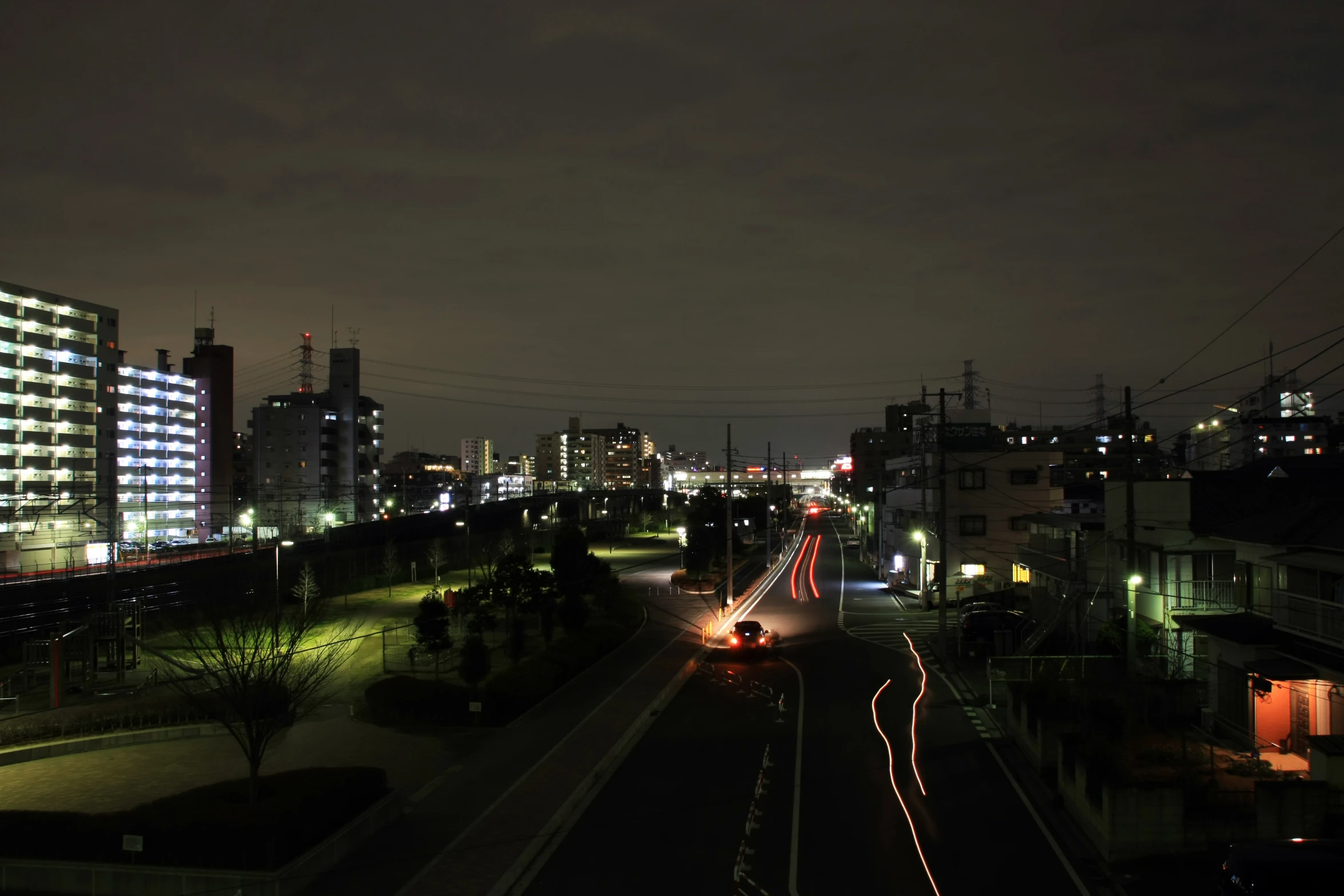 nighttime view of cars and buildings in an urban area