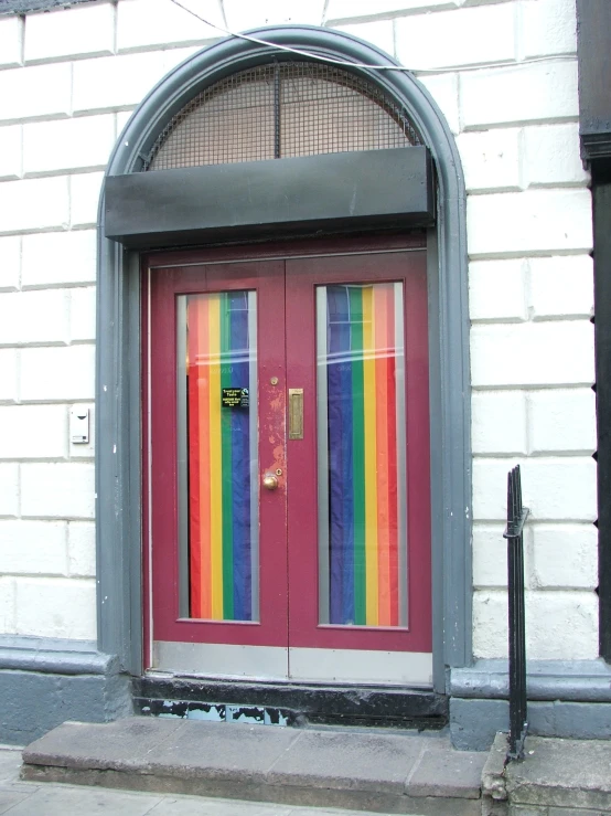 a red door with rainbow stripes in the door