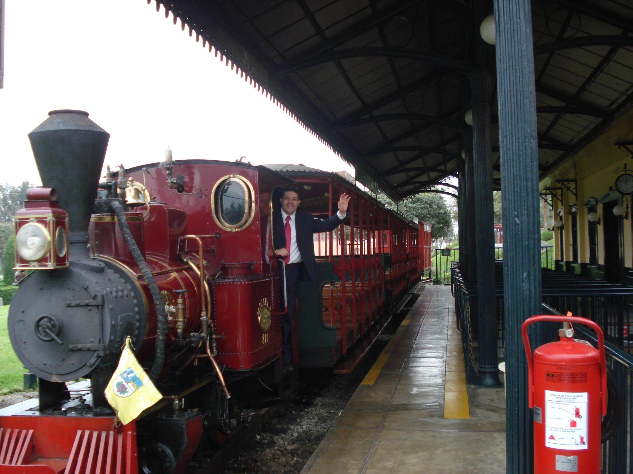 a red locomotive that is on the tracks