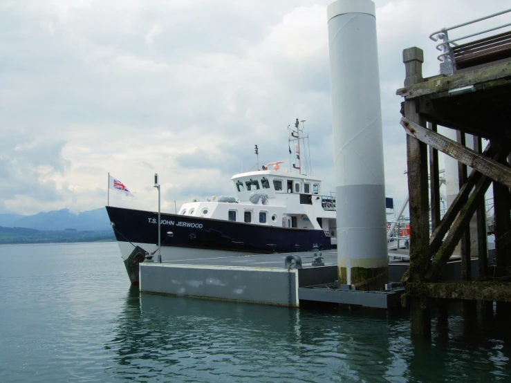 a large boat docked at a dock at the water's edge