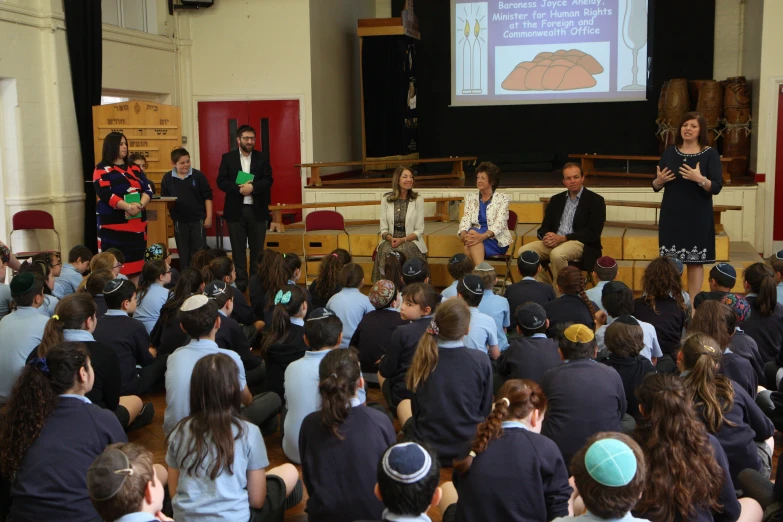 young children are shown at a lecture on education