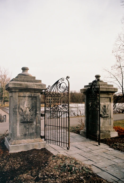 a gate and grave in front of some graves