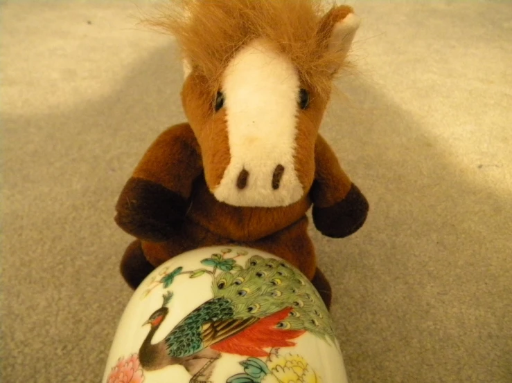 a small toy horse on a white surface
