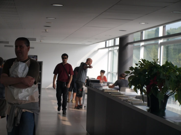 some people are in an airport lobby by the window