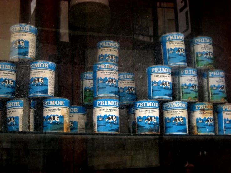 a bunch of cans that are stacked on a shelf