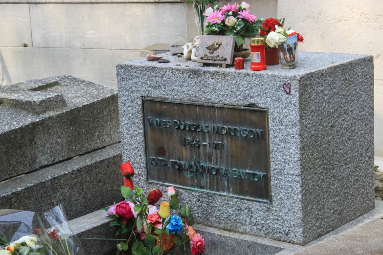 there is an image of a memorial with flowers and flowers