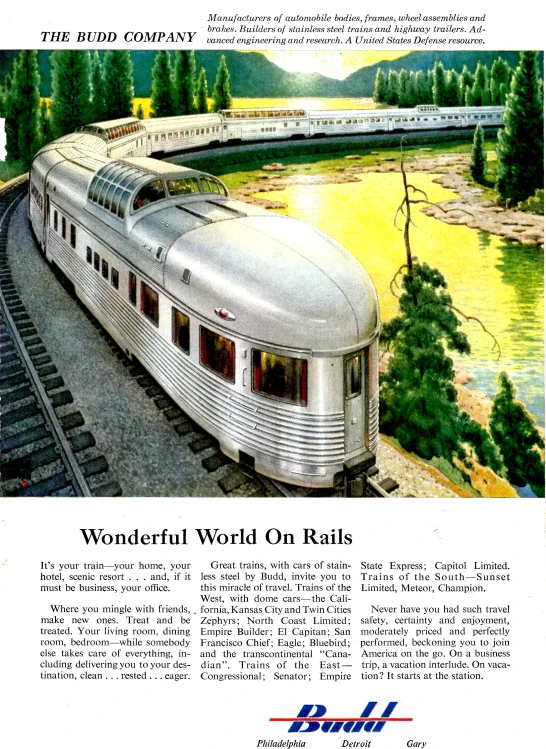 a train traveling down the tracks next to trees