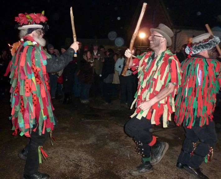 the men are dancing and holding flags in their hands