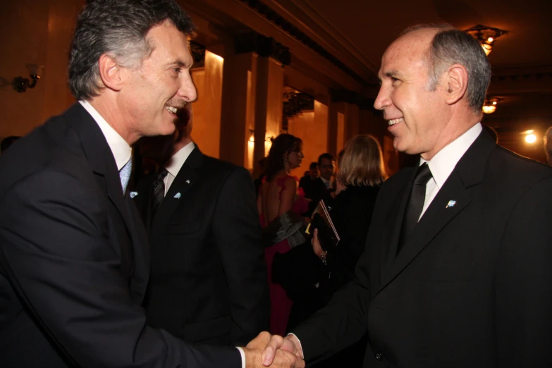 two men shaking hands at an event