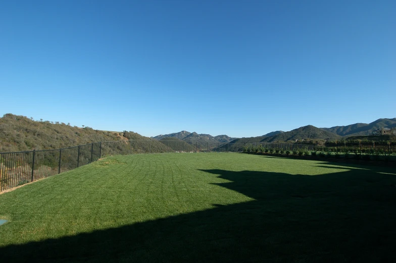 a hillside on top of a hill with green grass