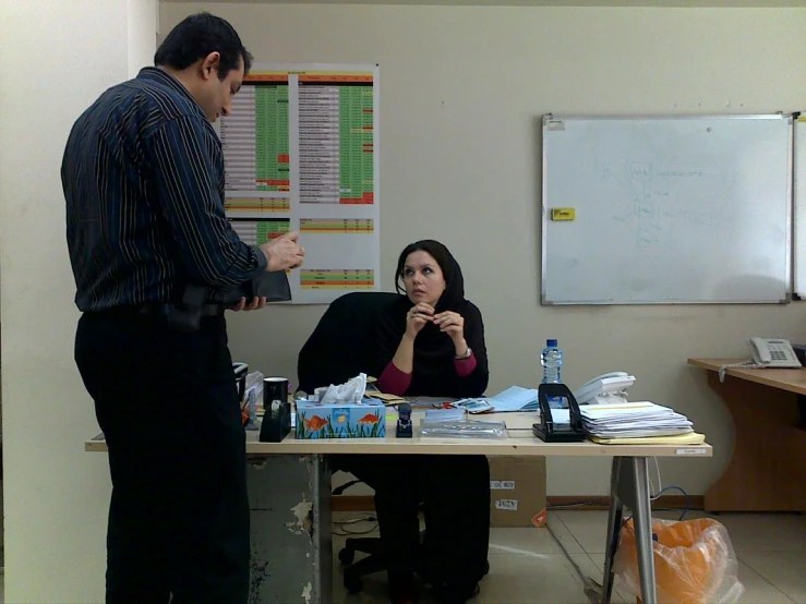 a man and woman are in an office setting