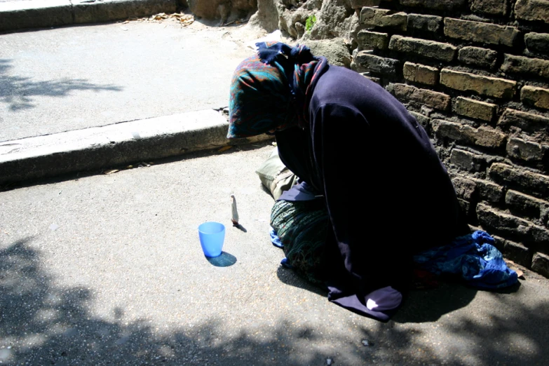 an image of a man looking for soing on the ground