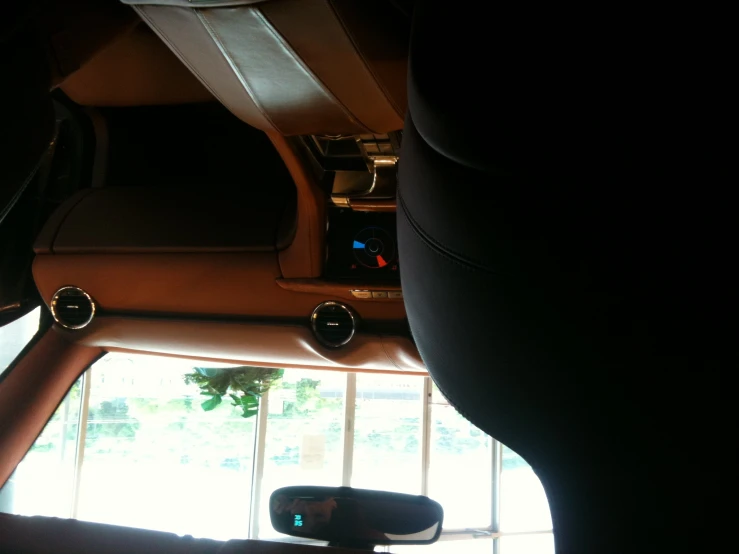 the view from inside a vehicle showing a dashboard and dash light