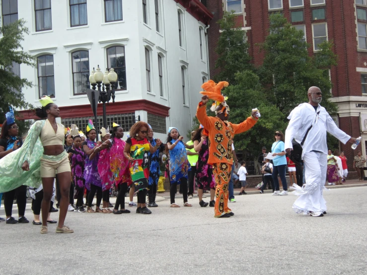 people dressed up in costumes walking down the street