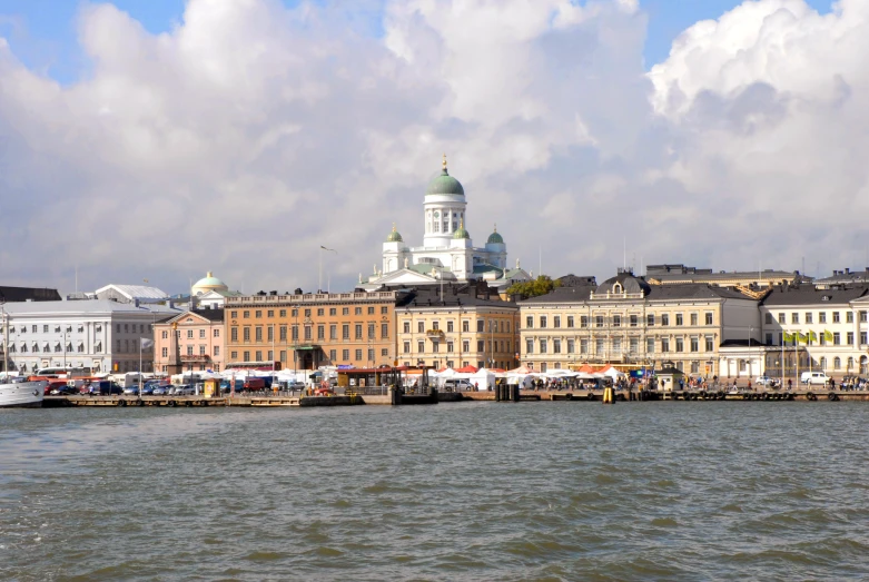 old buildings and a large river dock line the water