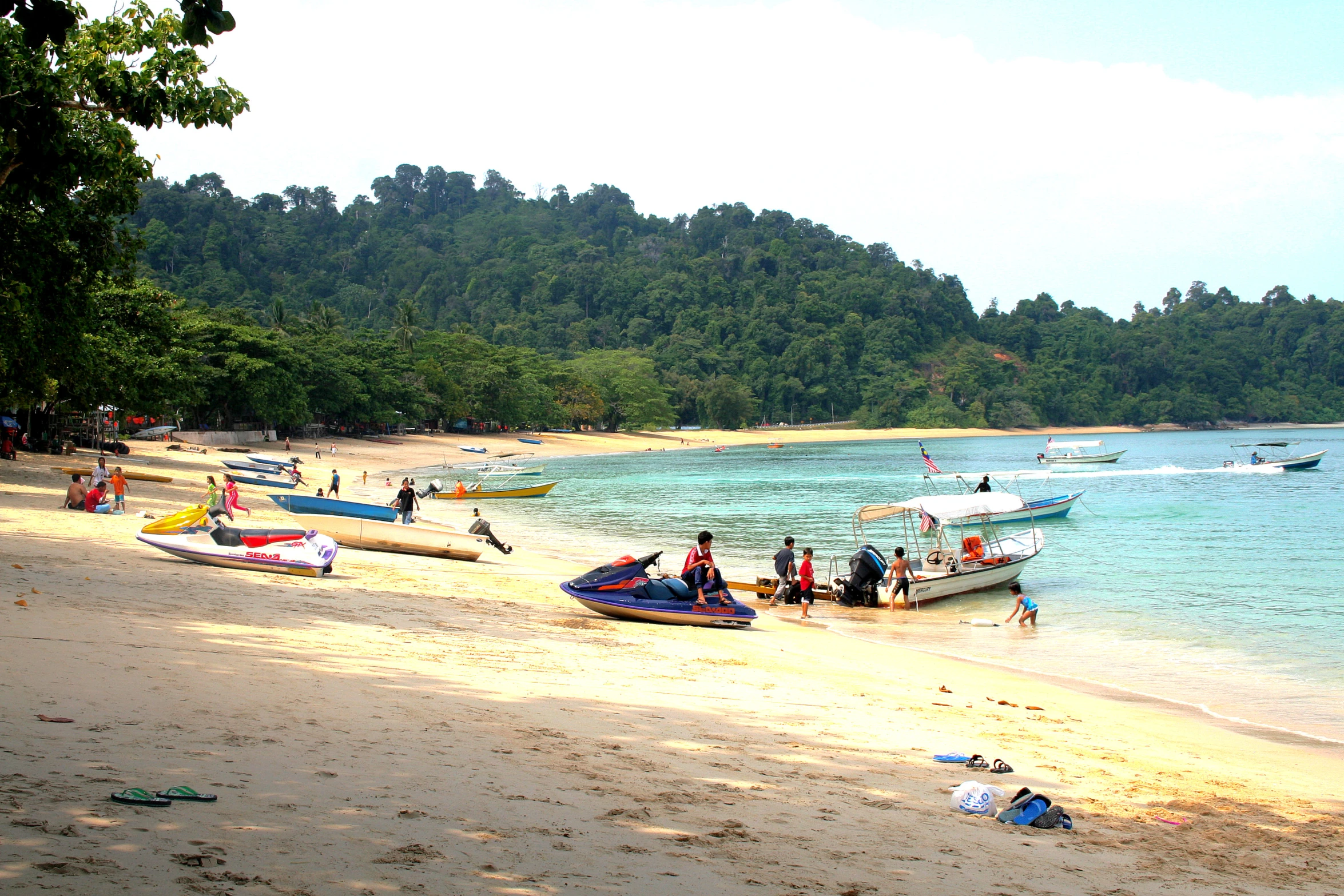 a sandy beach filled with lots of boats on top of it